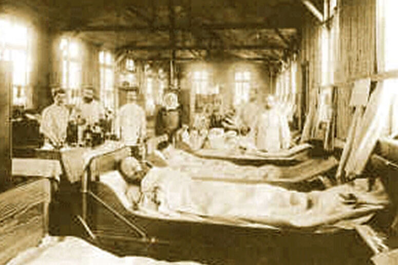 Altes Bild eines Krankenhauses mit vielen belegten Krankenbetten und Ärzten